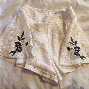 A beautiful white lace short with pretty flower